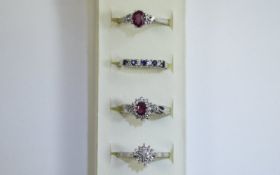 4 x Silver Rings Collection of rings in various designs featuring red and blue stone setting