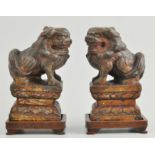 Pair of Eastern cast iron models, "Chinese Dogs of Fo" on stands, overall height 20cm.