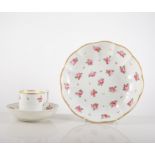 A Derby coffee can and saucer, early 19th Century, decorated with dispersed rose sprigs,