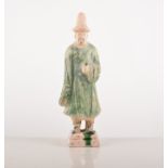 A Chinese straw glazed pottery figure of a man, Tang style, stepped square base, 21cms.