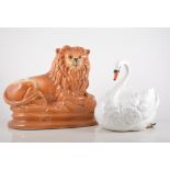 A pair of Staffordshire brown tan glazed lions, and two pairs of swans.