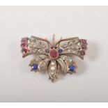 Rose and white metal butterfly brooch, set with sapphires, diamonds and garnets, 4.5cm.