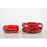 Three graduating Whitefriars ruby glass bowls, by Wilson and Dyer, diameter 20cm and smaller.