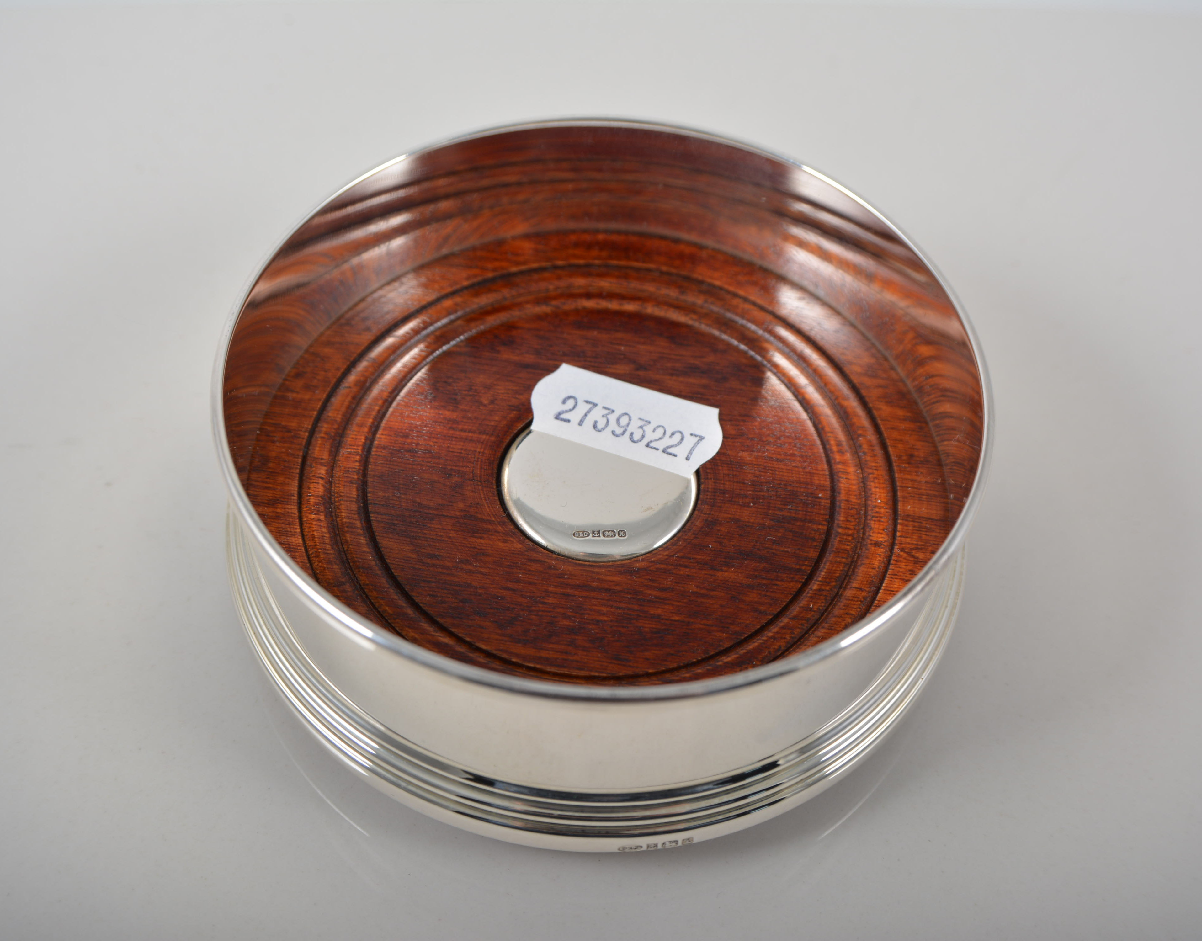 Modern silver coaster, mahogany base, diameter 10cms, boxed, plus two silver mounted dishes,