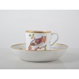 English pottery cup and saucer, decorated with birds of prey and flying insects,