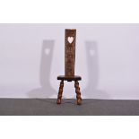 Carved oak spinning chair, 20th Century, erroneously dated 1566, seat width 30cms, height 97cms.