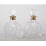 Pair of cut glass decanters, squat shouldered form with silver mounts, makers mark KMS Birmingham,