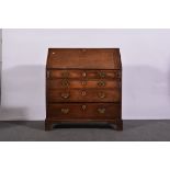 George III oak bureau, fall front enclosing an interior fitted with pigeon holes and drawers,