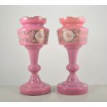 Pair of Victorian pink glass lustres, lacking droplets, enamel decoration with birds and foliages,