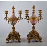 Pair of gilt metal twin light candelabra, fashioned as urns,