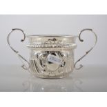 Silver porringer, twin scrolled handles, gadrooned and embossed, G.N.R.H., Chester 1903, height 9cm.