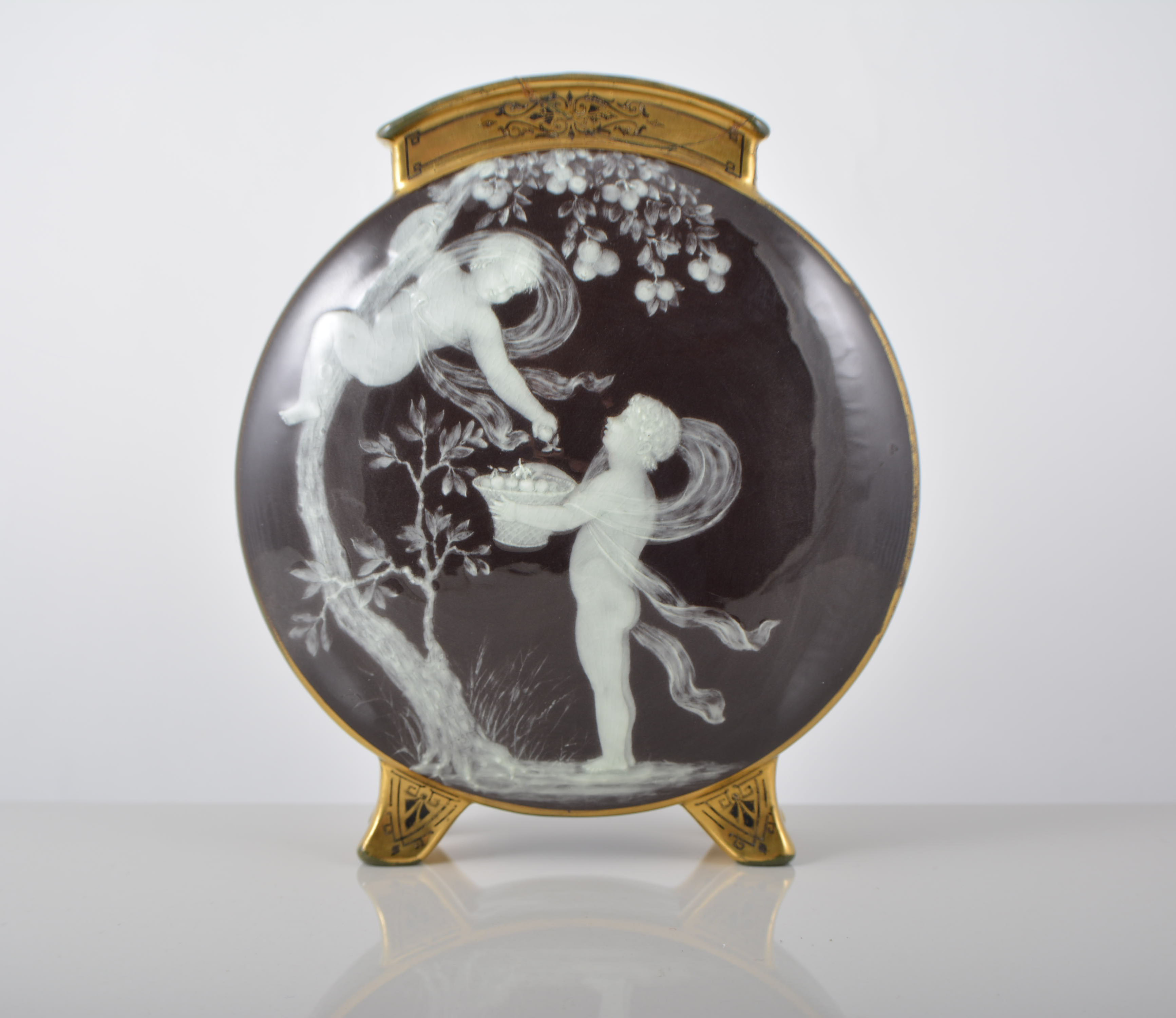 Moore pottery moon flask, with pate sur pate decoration of cherubs picking fruit, incised to body H.