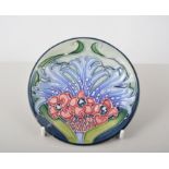 Moorcroft pottery, five coasters with various designs including Florian lilac stamp factory marks,