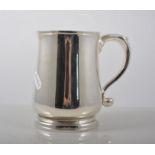 Modern silver tankard, waisted form with a scrolled handle, Comyns, London 1958, height 12cm.