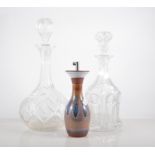 Cut glass globe and one decanter, with stopper, height 31cm, three other decanters and an oil pot,