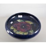 Moorcroft pottery shallow bowl, circular form, floral pattern, diameter 30cm, restored.