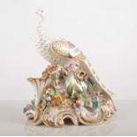 English porcelain model, Peacock, encrusted floral base, height 17cm, (a.f.).