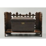 Gothic revival oak book rack, length 35cm, and Victorian mahogany tea caddy with a fitted interior,