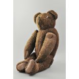Brown plush teddy bear, early 20th Century, bead eyes and jointed limbs, length 26cm,