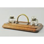 Edwardian oak desk stand, rectangular base, rounded corners, brass handle and with two ink wells,