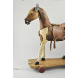 Vintage toy pull along horse, upholstered and with a leatherette saddle,