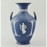Wedgwood dark blue ground two handled urn, applied decoration of figures, height 27.5cm.