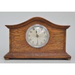 Oak cased mantel clock, arched top with a moulded cornice, circular dial signed Ferranti,