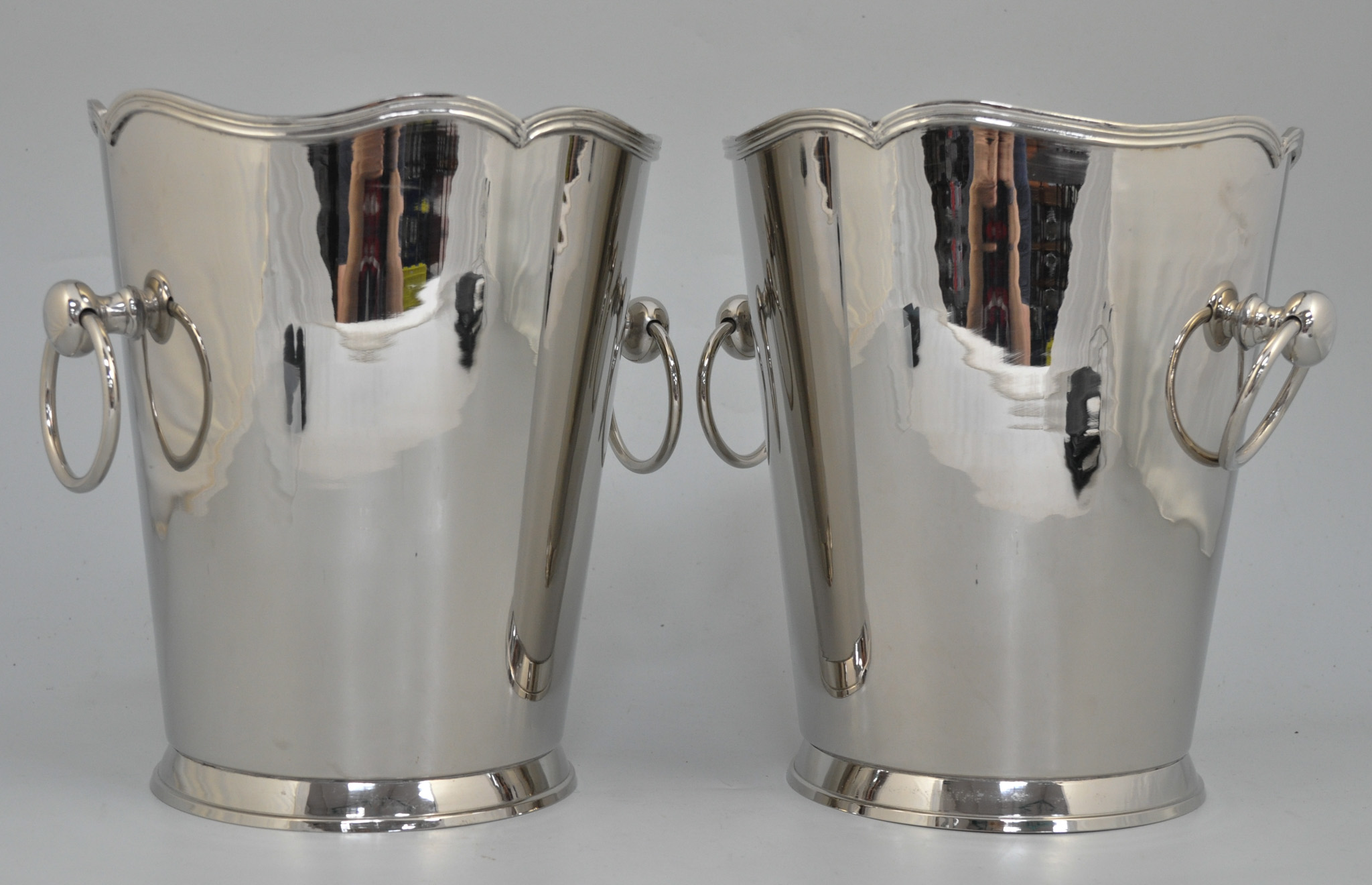 Pair of nickel plated wine coolers, shaped tops, ring handles, height 23cm.