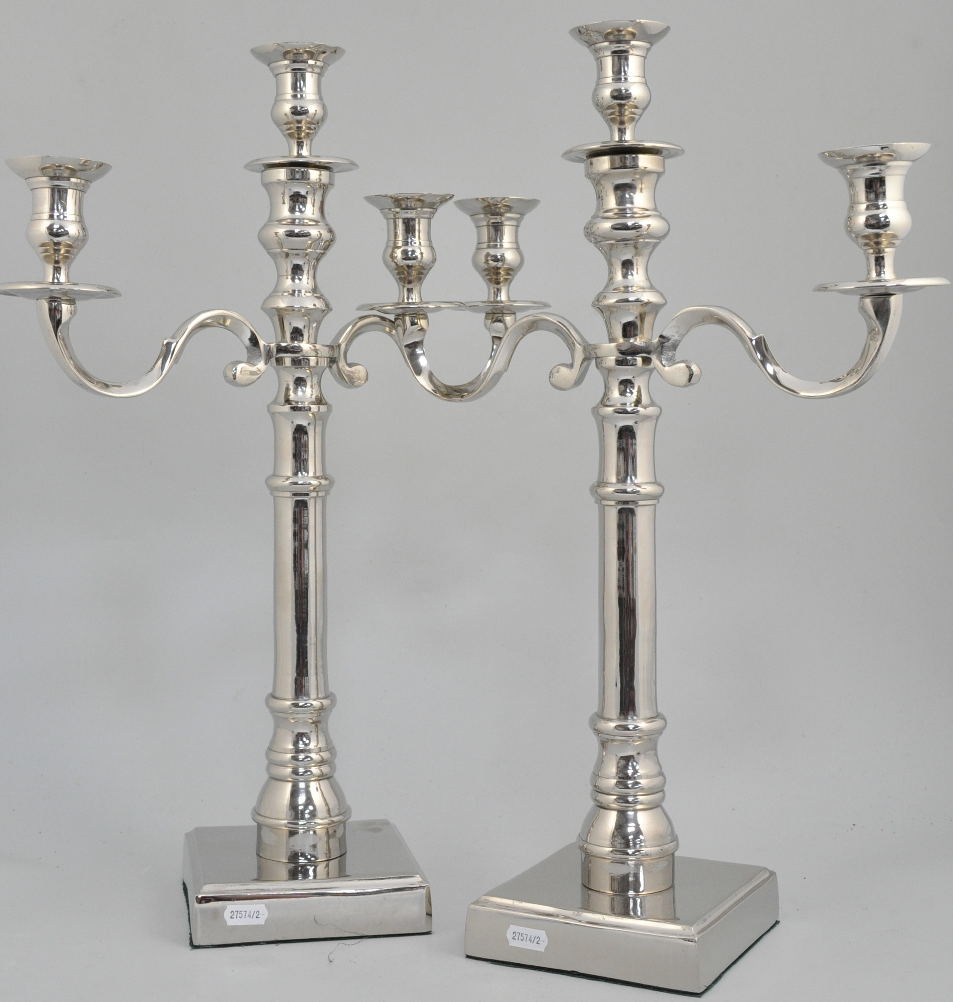 Pair of nickel plated table candelabra, each with three sconces and two scrolled branches,