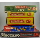 Five boxed sets of Meccano, some with motors.