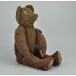 Brown plush teddy bear, early 20th Century, bead eyes and jointed limbs, length 26cms,