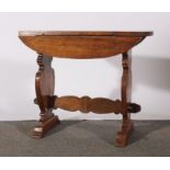 Stained wood occasional table, oval top, with two fall leaves,