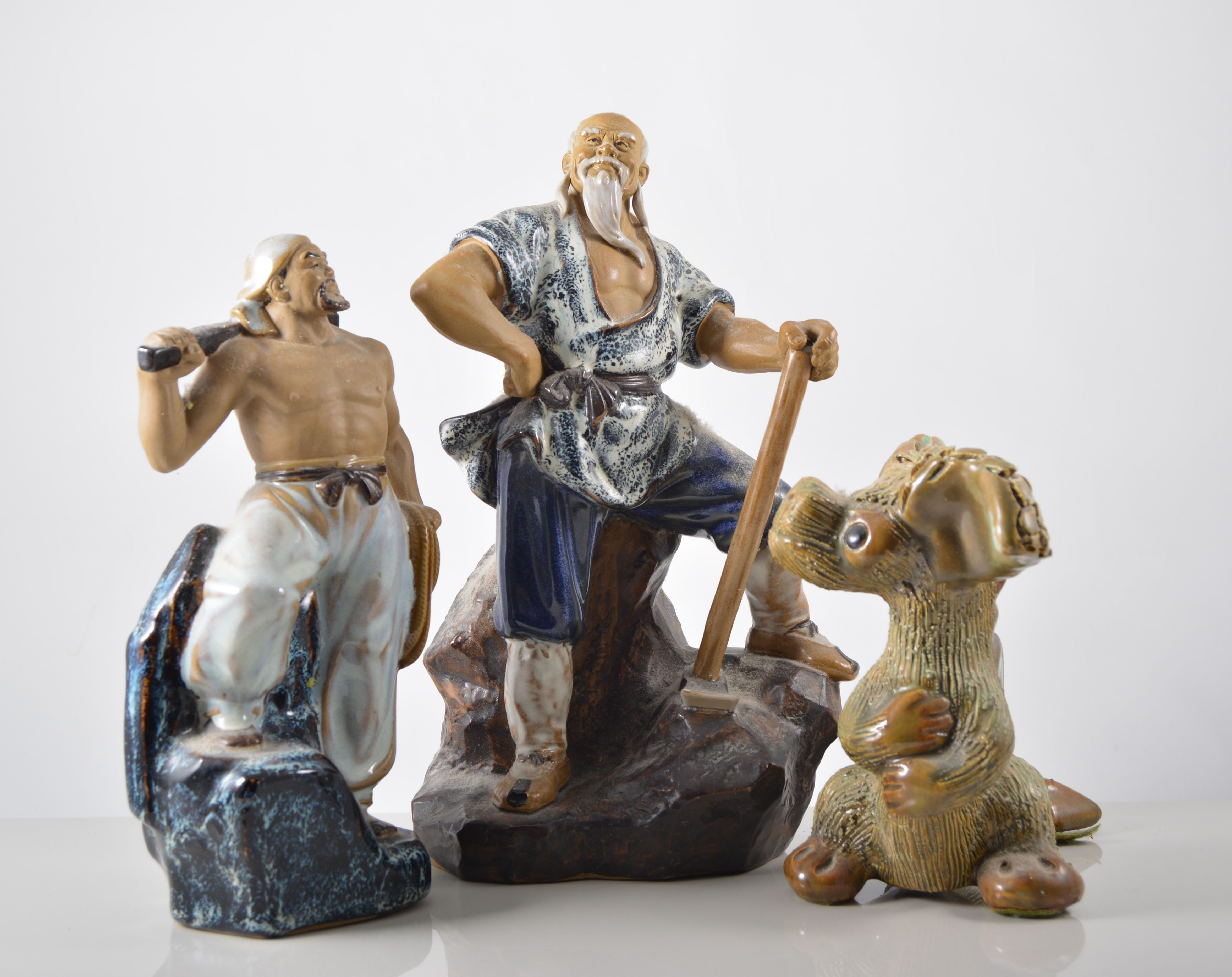 Three Far Eastern stoneware figurines,