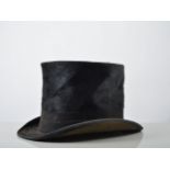 Silk top hat, labelled G H Holden, Peterborough and leather straps.