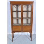 Edwardian mahogany two door display cabinet with satinwood stringing and fielded panels to base,