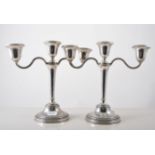 Pair of silver three light candelabra with detachable sconces and centre finial, filled bases,