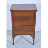 Walnut music cabinet, rectangular top with moulded edge, five drawers, fretted spandrels,