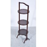 Walnut three tier folding cake stand, circular shelves, height 19cm.