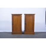 Pair of oak pot cupboards, each with a rectangular top, panel door, plinth base, width 41cm,