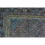 Persian pattern carpet, with a central lozenge medallion, red ground,
