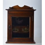 Edwardian oak cased smokers cabinet, glazed door, two drawer interior, width 29cm.