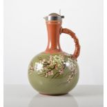 Torquay style pottery ewer, green glazed with blossom spray, silver cover, Sheffield 1879, 18cm.