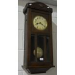 Oak cased twin train wall clock, striking on a gong, with Arabic numeral chapter ring,