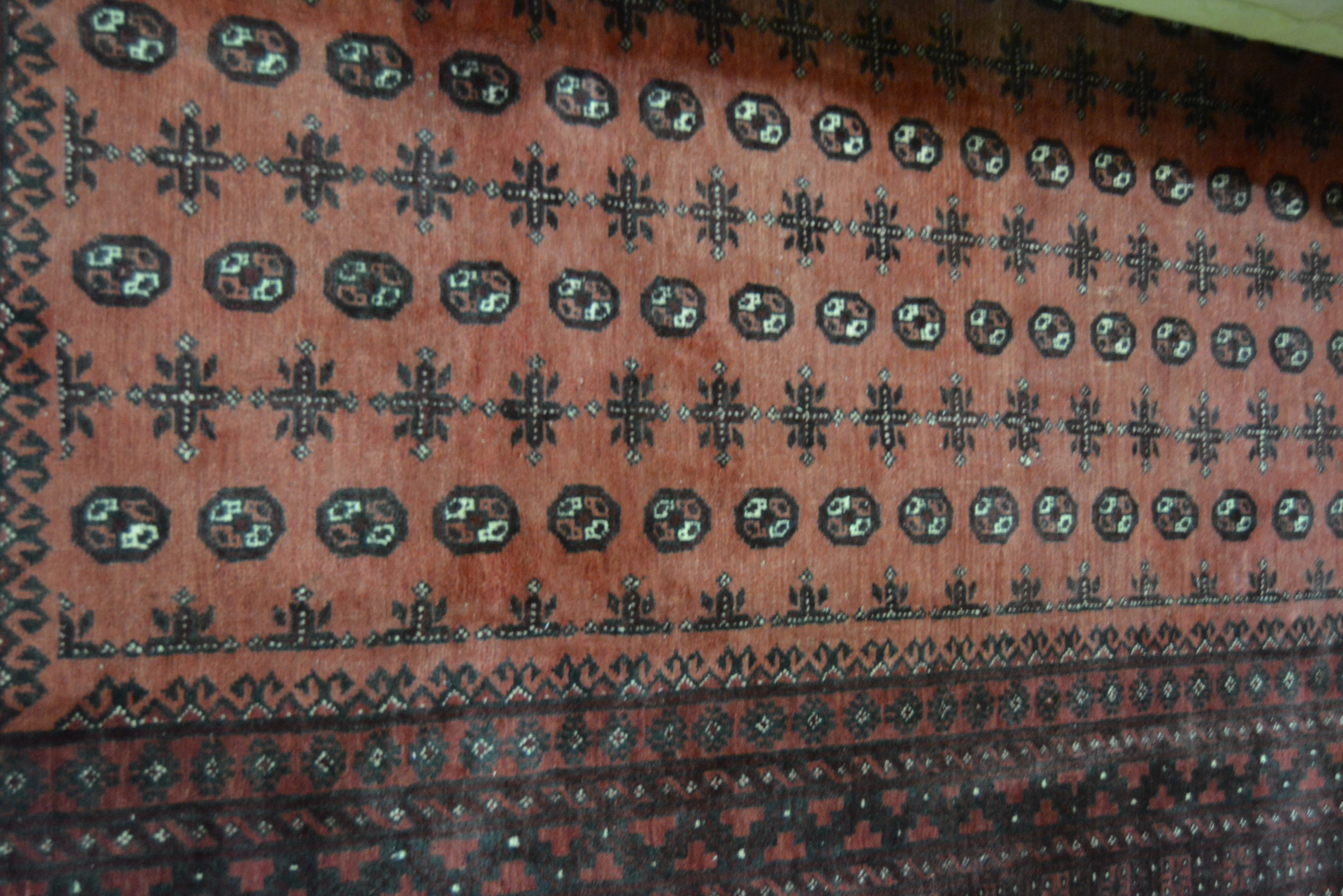 Turkmen rug, red ground with rows of tiles within multiple borders, 287 x 205cms.