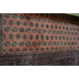 Turkmen rug, red ground with rows of tiles within multiple borders, 287 x 205cms.