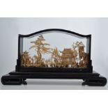 Far Eastern cork work carving, Pagodas and foliage, within a glazed case, width 47cms,