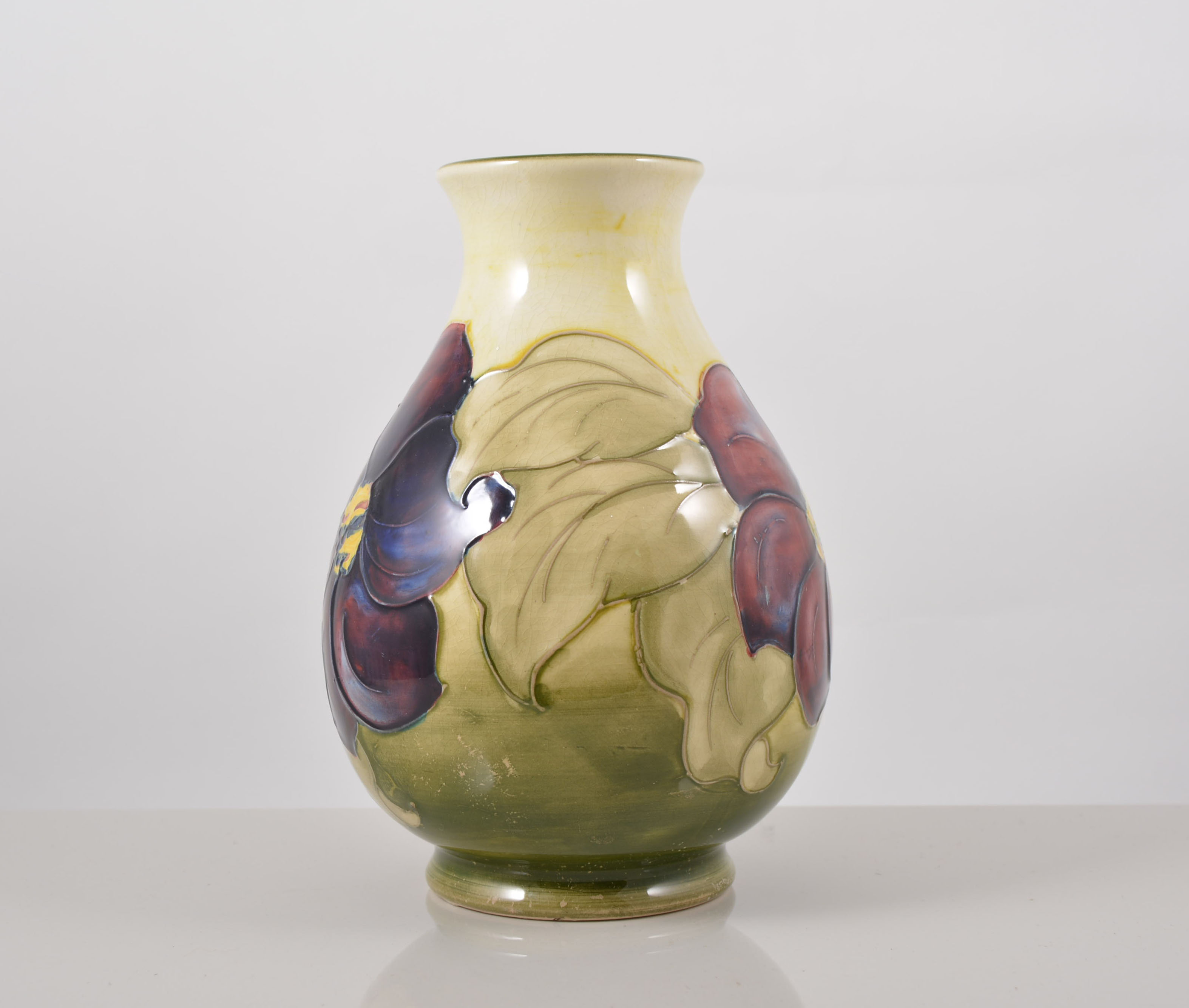 Walter Moorcroft, a 'Anemone' vase, circa 1950, pear shape on a yellowish green shaded ground,