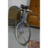 A vintage bicycle. with bell and saddle bag.