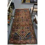 Hamadan rug, four lozenge medallions within blue guards, meandering border, 250 x 110cms.