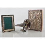 Small embossed white metal mounted book, height 15cms, a photograph frame, napkin rings,